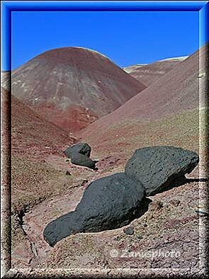 Cathedral Valley, schwarze Felsbrocken finden wir vor diesem Kugelberg